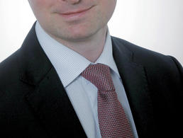 Headshot of Michał Chabros.